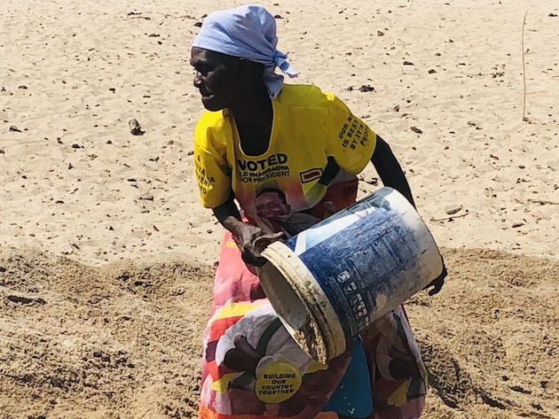 Picture B Enia Tambo using bucket